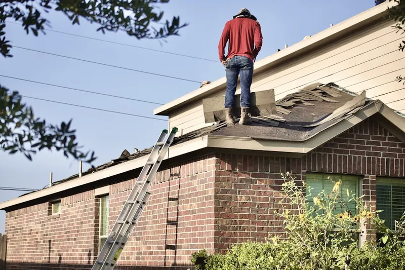 Professional roofer working on a residential roof in Blandon